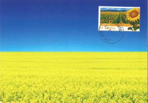 A Stamp Out War maxicard: golden field under a blue sky